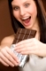 Chocolate - portrait of young woman bite off sweets