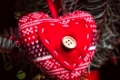 Handmade knitted heart - christmas decoration on the fir branch