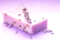 Soap with dry lavender over lilac background