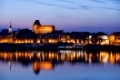 Torun city skyline at twilight in Poland, Old Town at Vistula River waterfront.
